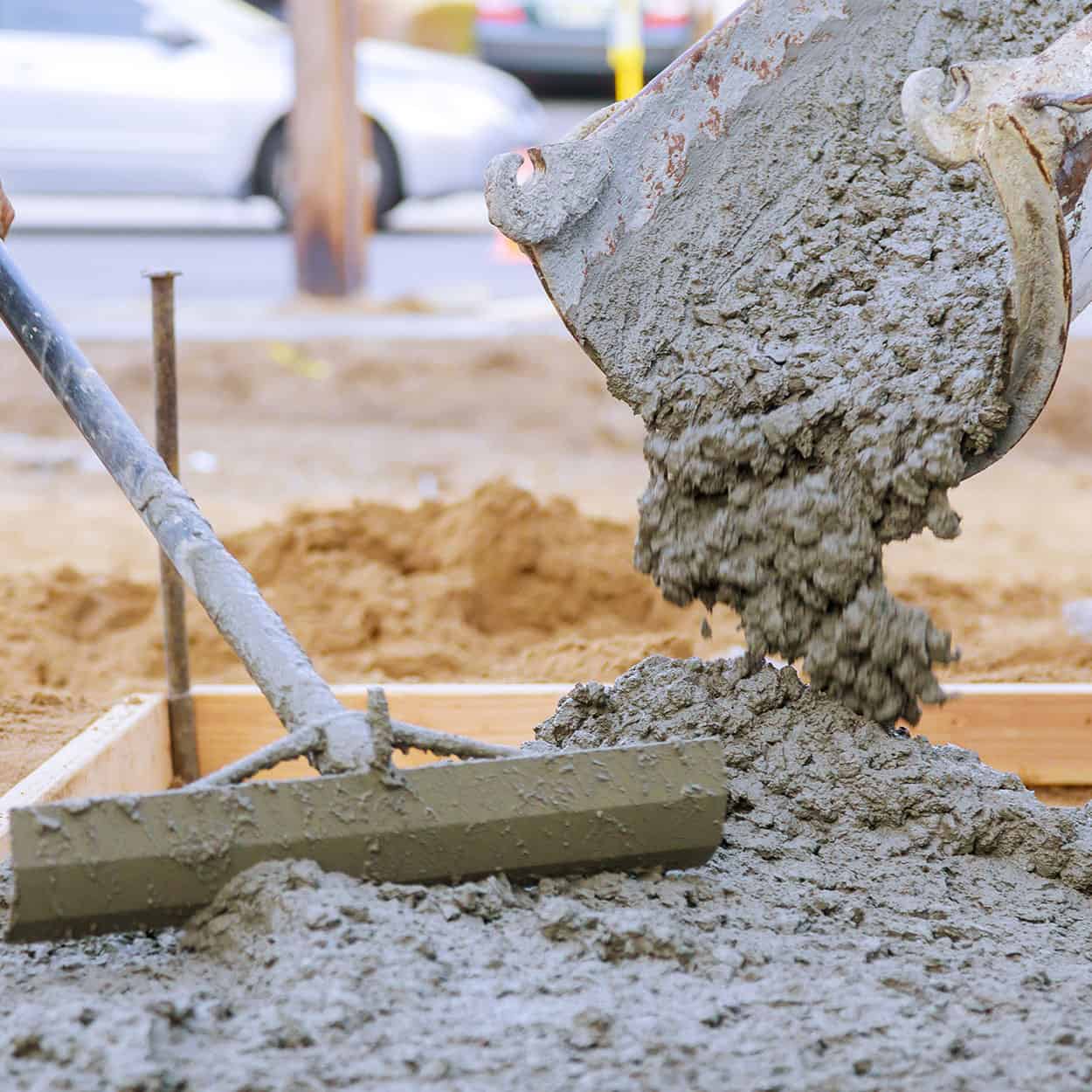 Concrete being poured into a new foundation base