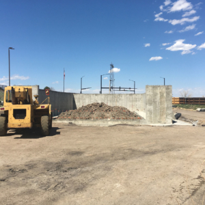 A bulldozer in front of a cement building project