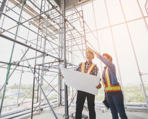 Construction Workers Pointing and Looking Upward