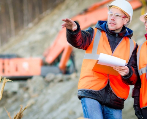 Construction workers look over building plans