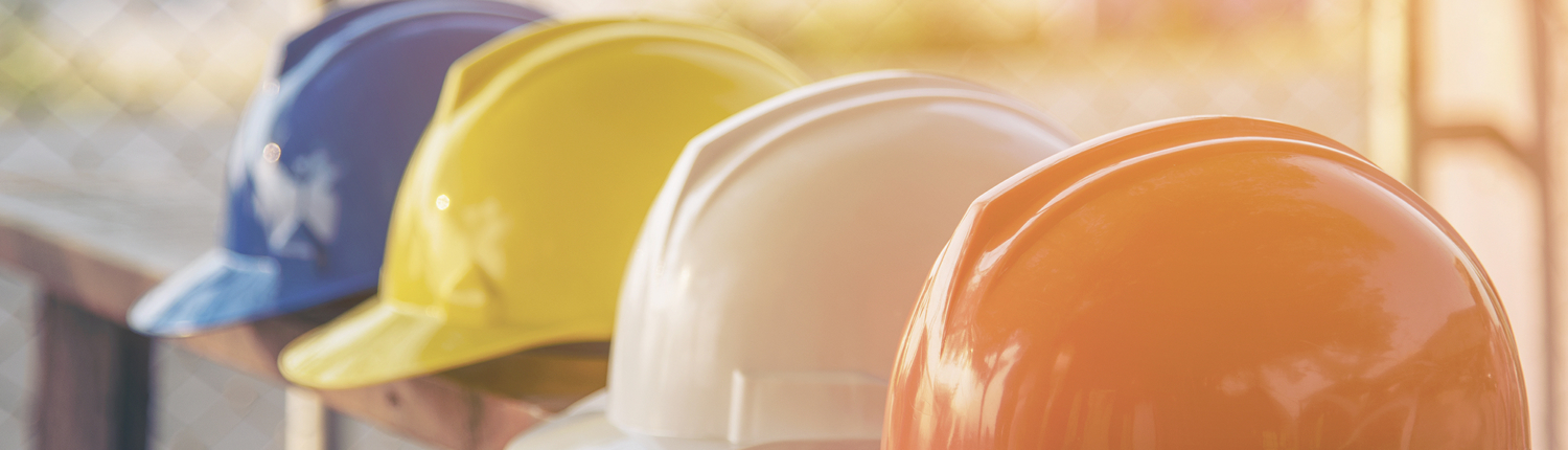 Hard-hats lined up on a bench