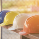 Hard-hats lined up on a bench
