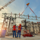 Workers watching a metal building construction process take place