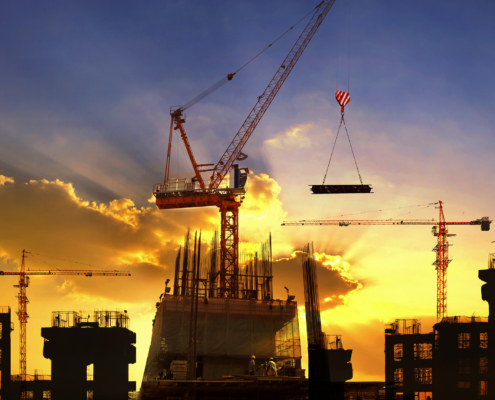 A crane moving metals while building a new facility