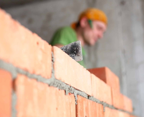 people performing masonry services