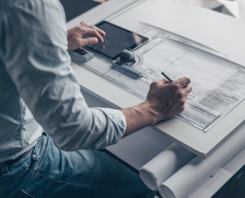 Image of an engineer designing blueprints for a construction project.