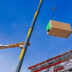 Crane lifting a prefabricated wooden building module