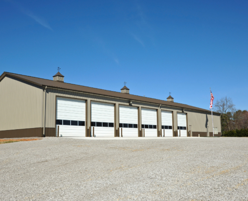 Side view of the exterior of a firehouse on a clear sunny day