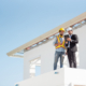 Construction engineer and architect team working together with blueprints discuss on the rooftop outdoor at construction site