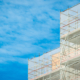 Scaffold sheeting net wrapped apartments building during insulation