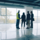 Diverse group of businesspeople standing inside newly constructed industrial building