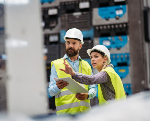Industrial team evaluate the production process in high tech manufacturing plant
