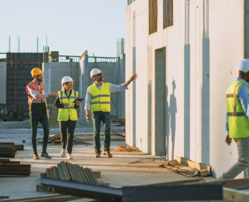 Diverse Team of Specialists Taking a Walk Through Construction Site