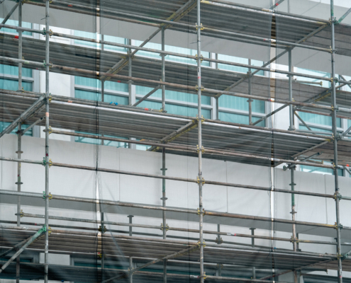 Metal scaffolding pipe framework construction was installed on the commercial high-rise building